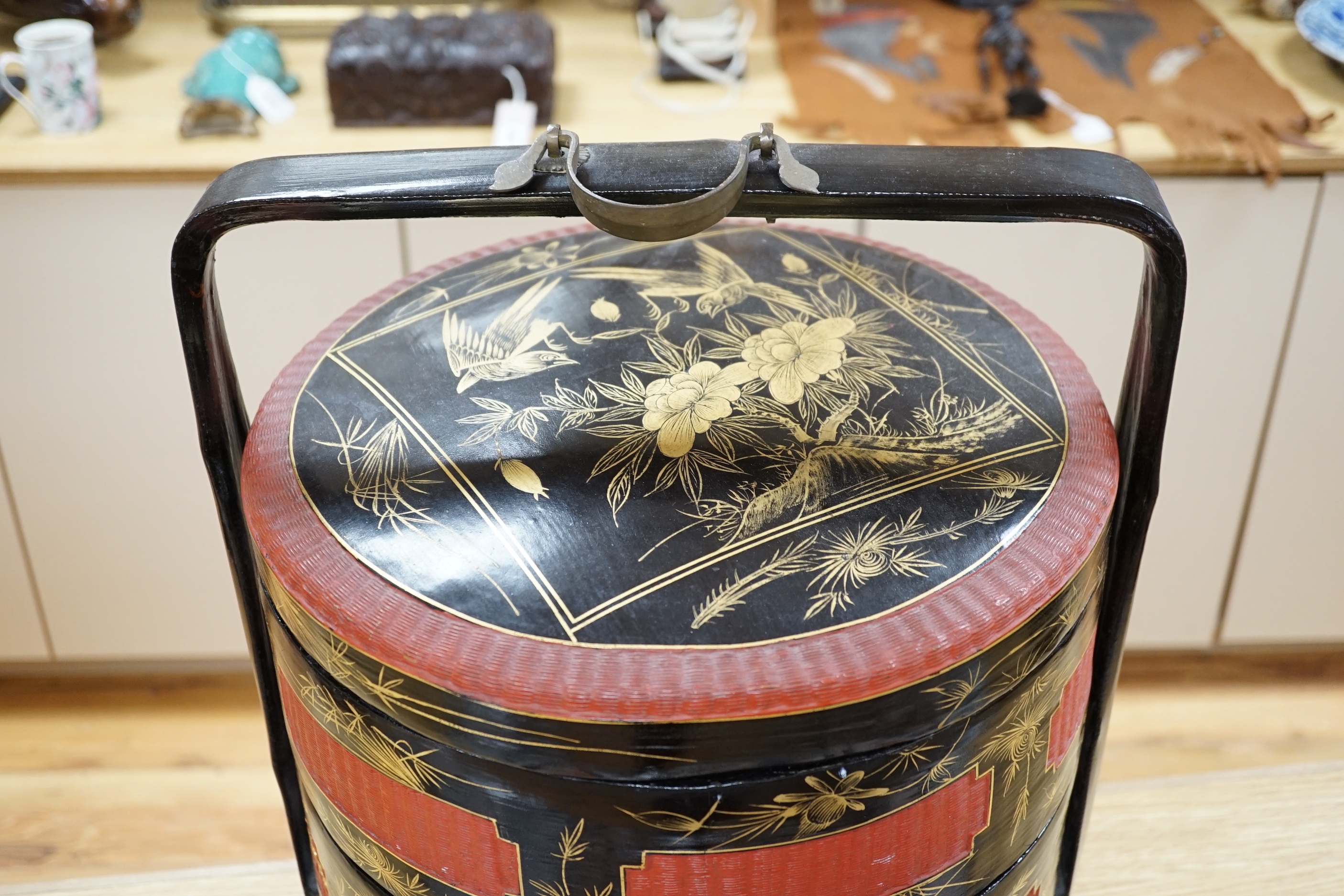 A Chinese three section lacquer wedding basket with gilded decoration